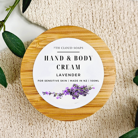 Hand and body cream container with lavender design on a textured surface