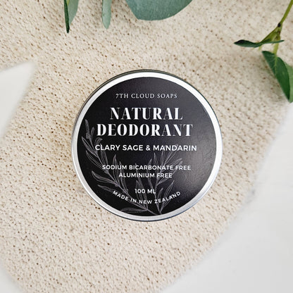 A jar of natural deodorant labeled 'Natural Deodorant Clary Sage & Mandarin' by 7th Cloud Soaps, indicating it is sodium bicarbonate free and aluminum free.