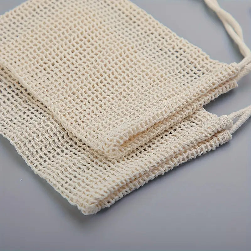 A beige natural exfoliating sisal soap bag with a textured weave pattern.